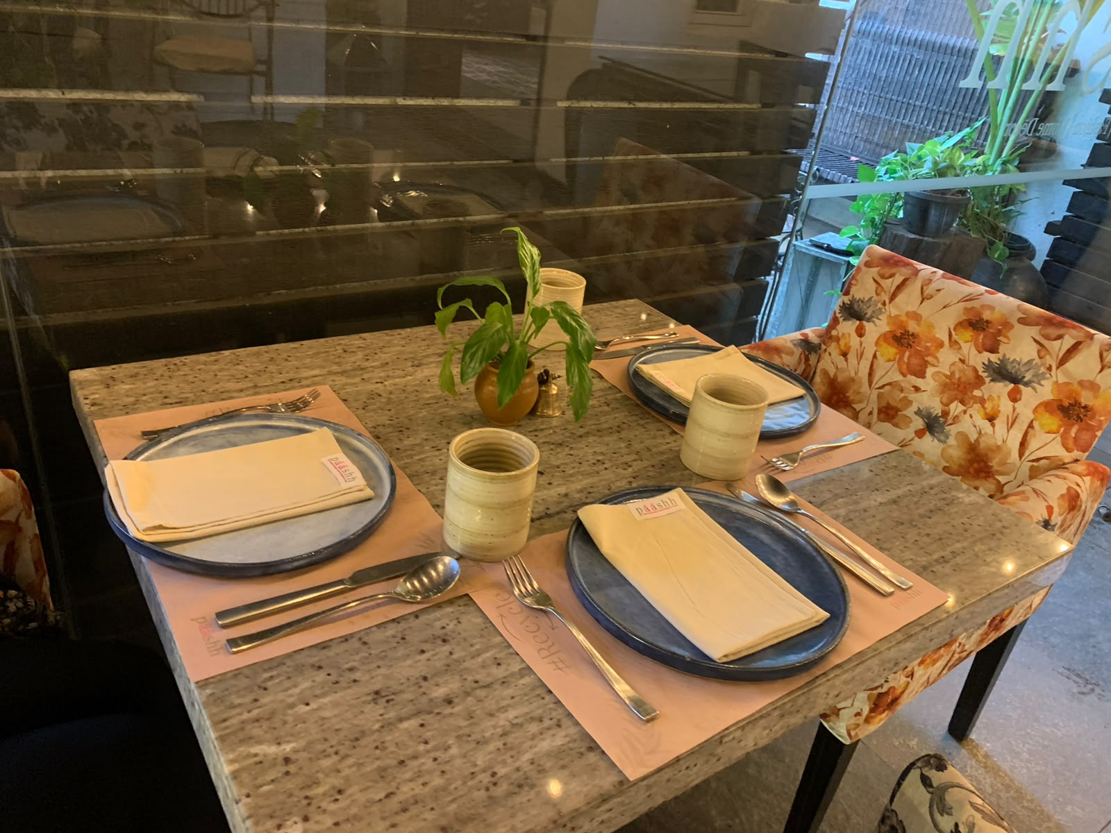 Paashh table setting with cream napkins and pottery