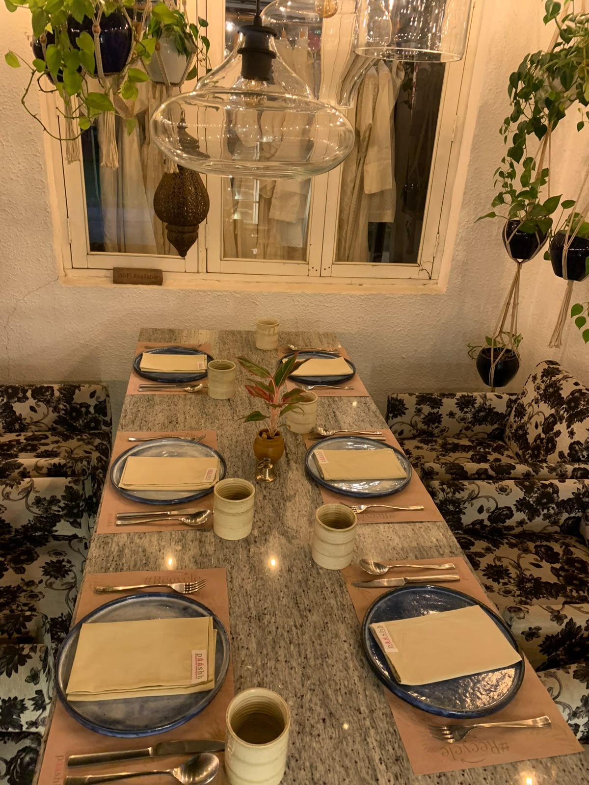 Paashh long table with cream napkins and floral seating