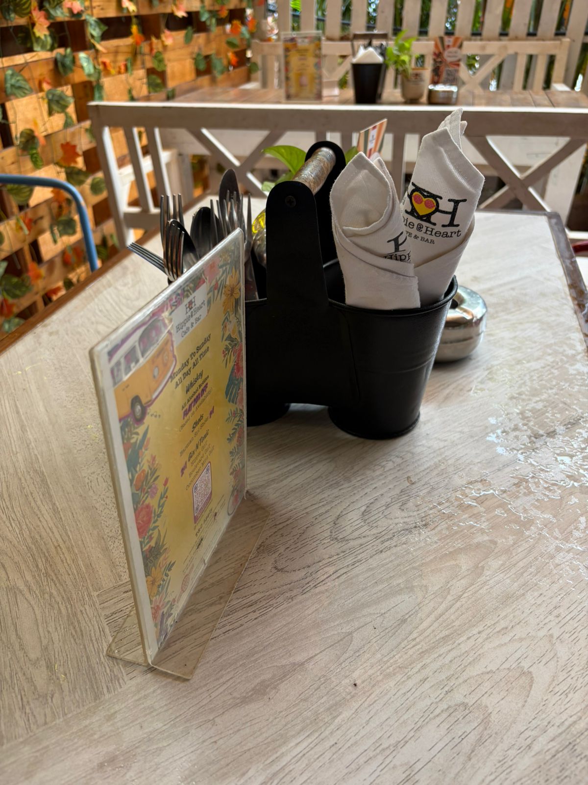 Hippie @ Heart outdoor cafe table with menu card and napkin caddy