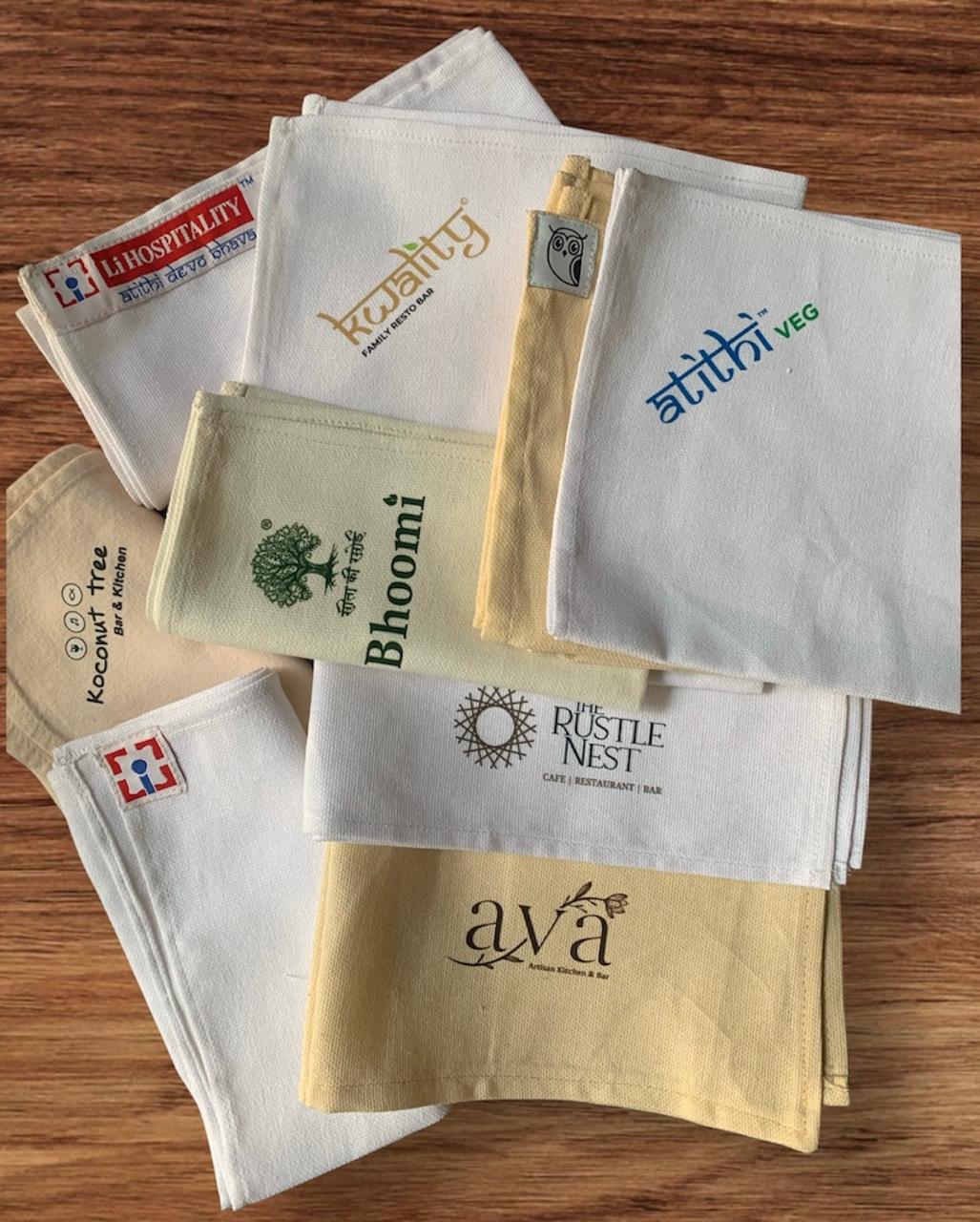 Custom branded napkin collection on wooden surface