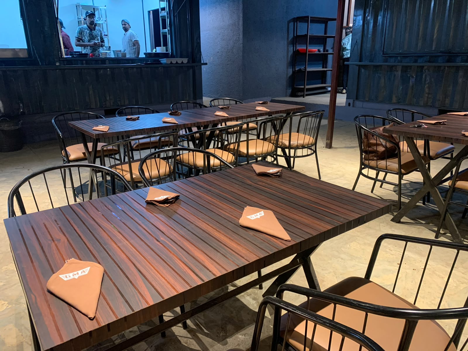 GMA branded brown napkins on wooden tables