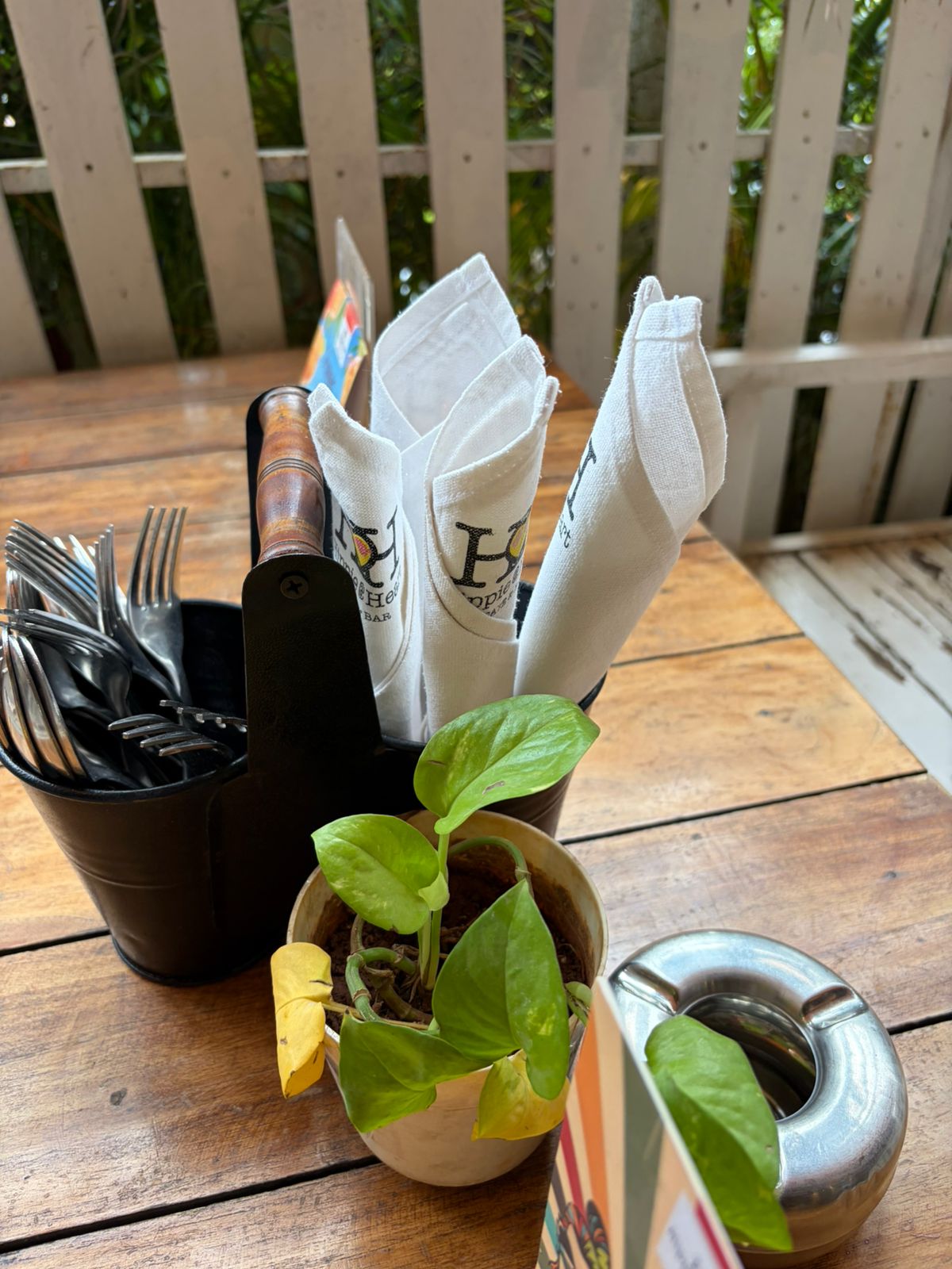 Hippie @ Heart branded white napkins in caddy on outdoor deck