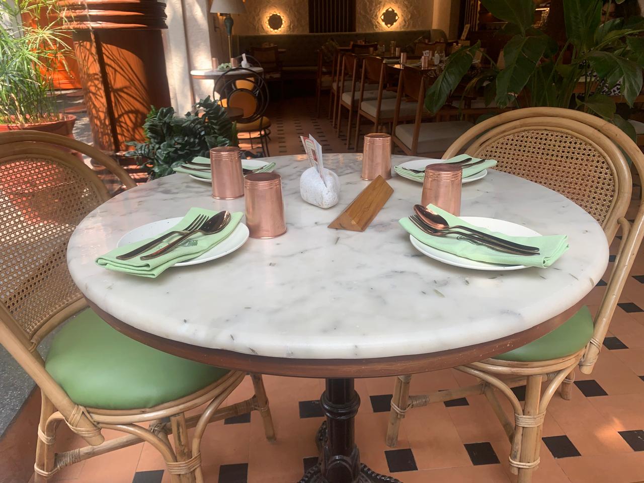 Café marble table setup with rattan chairs