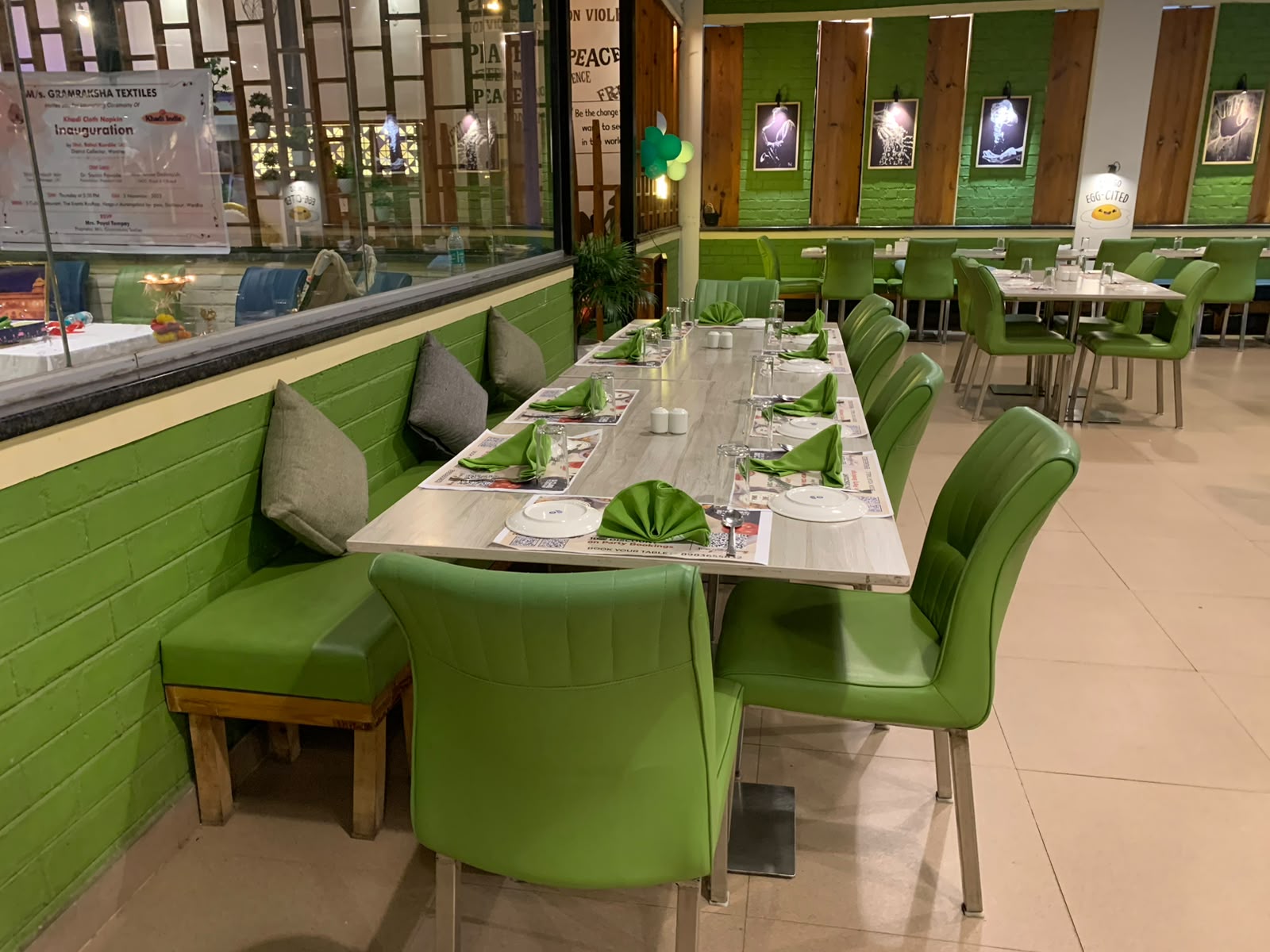Scube Restaurant dining hall with green banquette seating