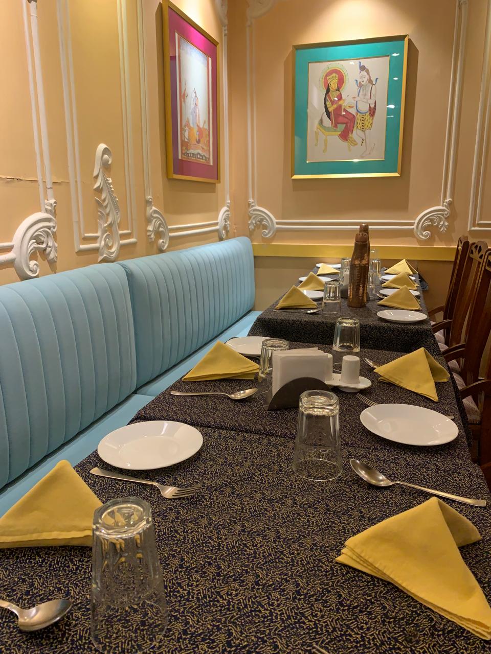 Elegant banquette dining with framed artwork