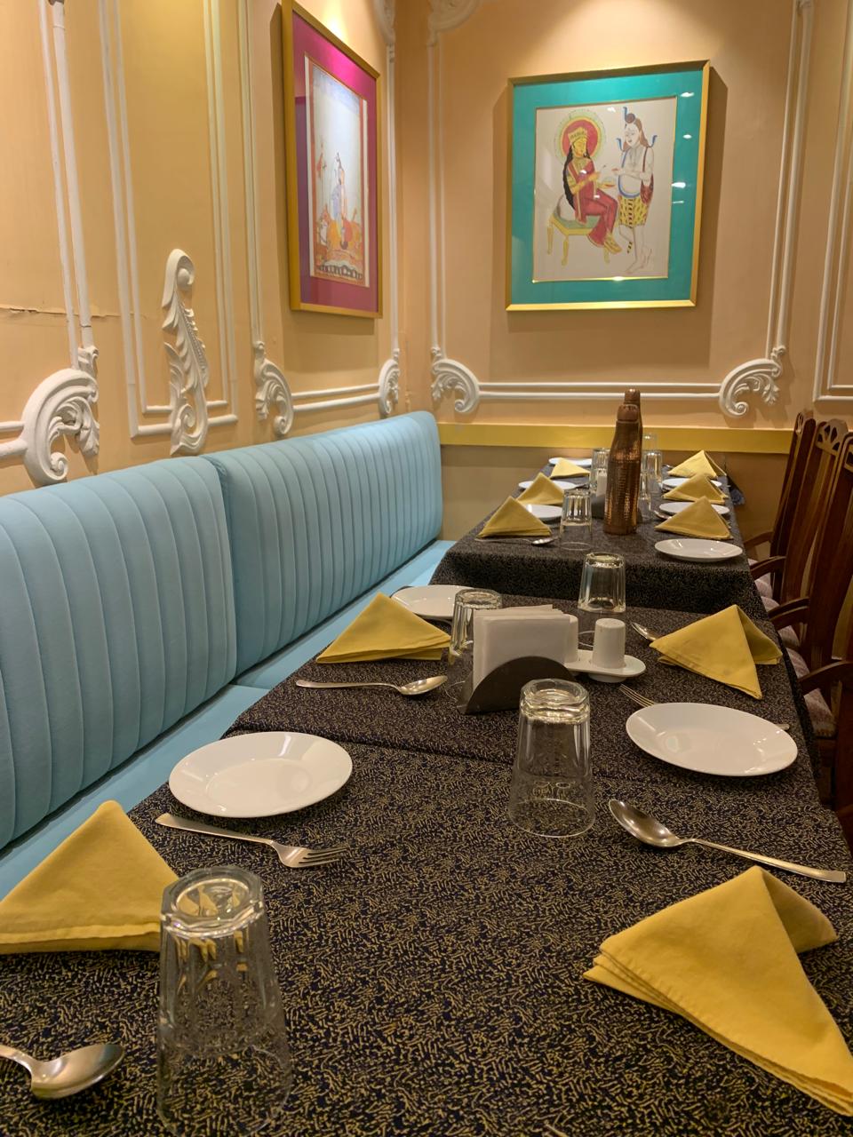 Heritage Indian restaurant booth with yellow napkin setup