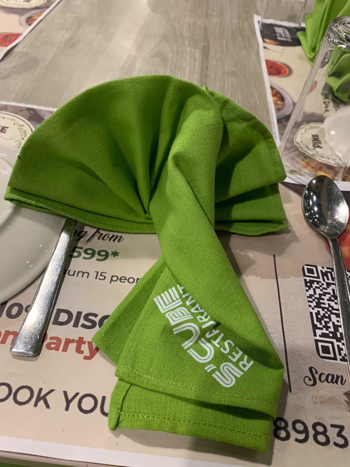 Scube Restaurant green branded napkin fold